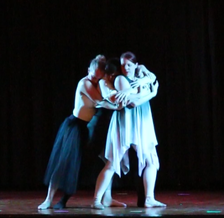 A still image from the ballet "Tenebrae"of three dancers in an embrace.